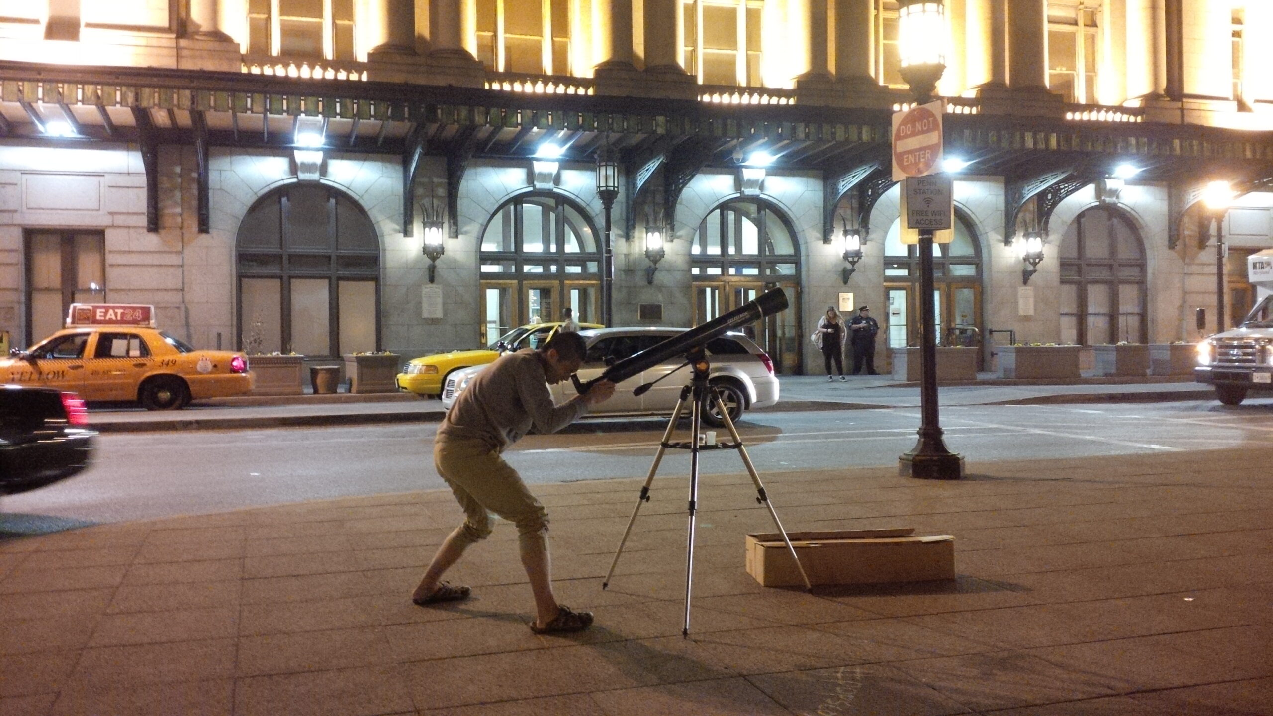 A Popscope member in New York City aiming his telescope