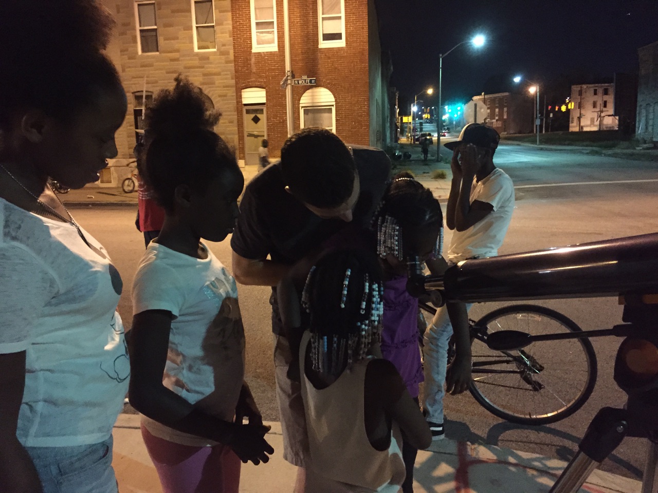 Stargazers on Wolfe Street in Baltimore see the rings of Saturn